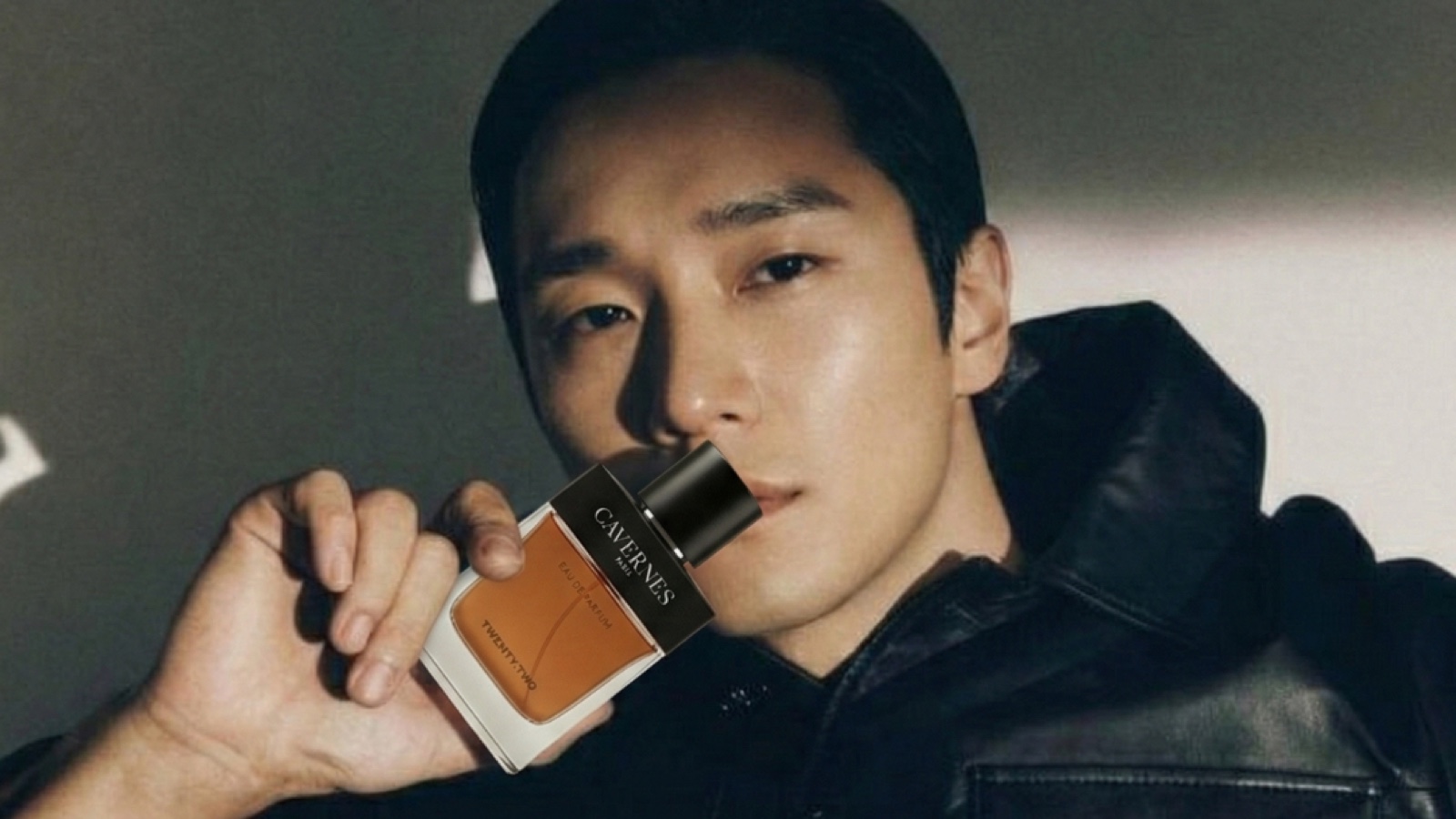 TW Care fragrance campaign model holding a Cavernes perfume bottle