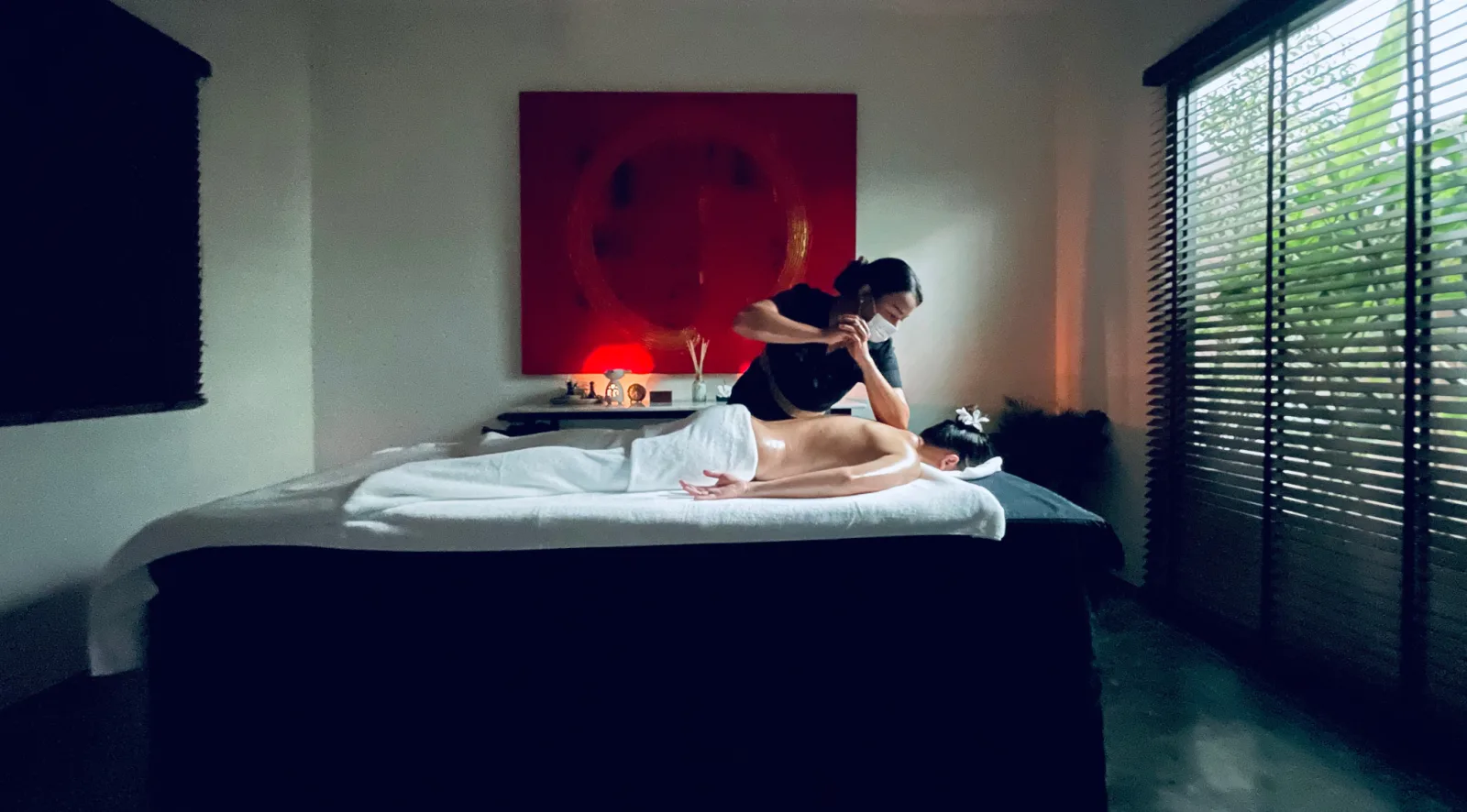 Loft Thai Spa Bangkok treatment room with therapist performing massage